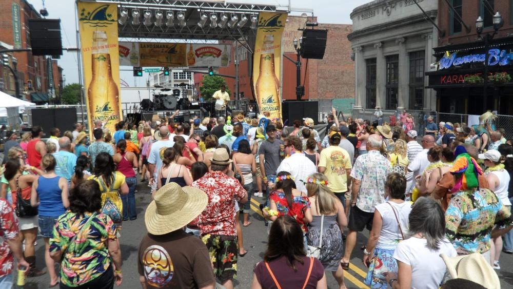 Large crowd at an outdoor street festival stage